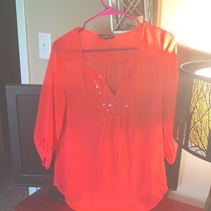 Size small bright pink top with sequenced embellishment .